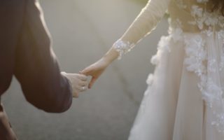 newlyweds holding hands