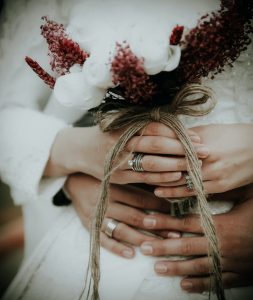 person holding white flowers